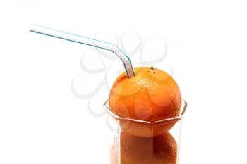 Tangerines with straws in a glass on a white background