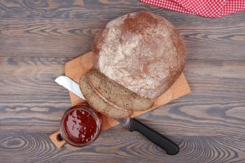 Bread and jam on wooden background top view