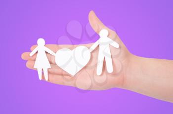 Royalty Free Photo of a Person Holding a Paper Family