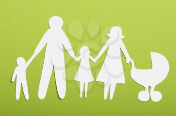 Closeup of paper family on green background