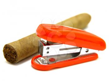 Red stapler and cigar on a white background