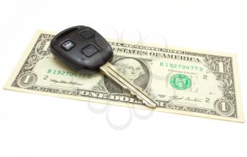 The car key lies on a dollar isolated on white in a background