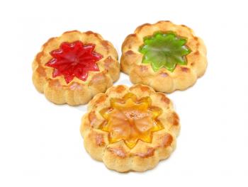 Cookies of yellow color with a stuffing from multi-colored jelly in the middle on a white background