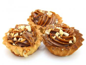 Pie a basket with chocolate condensed milk and nuts on a white background
