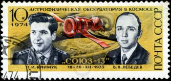 USSR - CIRCA 1974: A post stamp printed in USSR devoted astrophysical space observator, shows portraits of cosmonauts Klimuk and Lebedev, circa 1974