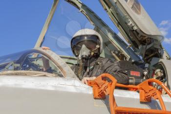 Military pilot in the cockpit of a jet aircraft.