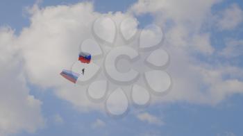 MOSCOW - SEP 2: the paratrooper descends on a parachute with the flag of Russia at a celebration in honor of the 70th anniversary of the launch of the first aircraft An-2 on September 2, 2017 in Moscow, Russia.