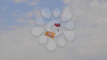 MOSCOW - SEP 2: the paratrooper descends on a parachute with the flag at a celebration in honor of the 70th anniversary of the launch of the first aircraft An-2 on September 2, 2017 in Moscow, Russia.