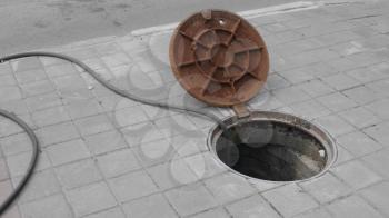 Close up of metal cover over concrete manhole at construction site.
