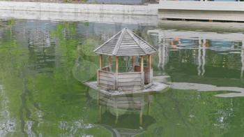 Wooden Duck House on a Pond in Rural