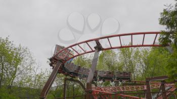 MOSCOW, RUSSIA, May 21, 2017: Children go in roller coaster and having fun on a cloudy day, Moscow