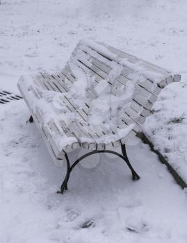 White wooden bench in the park on the street