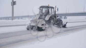 MOSCOW - JANUARY 16: Tractor cleaning snow in field on January 16, 2020 in Moscow, Russia.