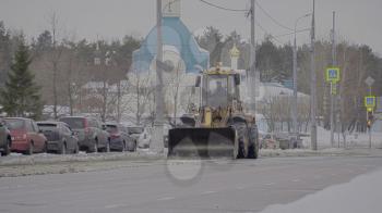 MOSCOW - JANUARY 16: Tractor cleaning snow in field on January 16, 2018 in Moscow, Russia.
