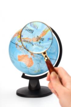 Japan map. Hand holding magnifying glass over earth globe Japan territory.