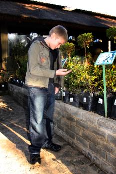 Royalty Free Photo of a Young Boy Looking at Plants