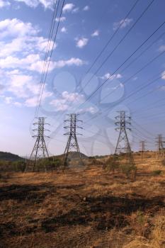 Royalty Free Photo of Large Power Cable Towers Running Through a Rural Area