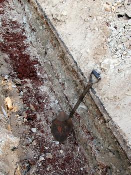 Royalty Free Photo of a Shovel in a Deep Trench