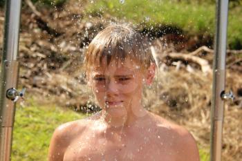 Portrait of Boy Washing Under Open Beach Shower