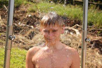 Portrait of Smiling Boy Washing Under Open Beach Shower