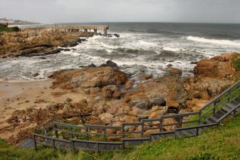 Picture of Curved Wooden Steps and Concrete Jetty in Storm over Sea