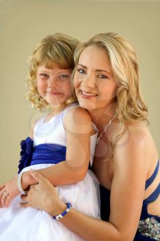 Lovely blond mom and daughter studio photo
