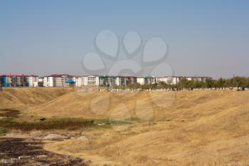 Cemetery next to houses Nursat, Shymkent, Kazakhstan