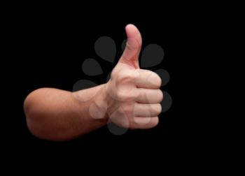 Thumbs up hand isolated on black background 