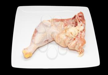 fresh chicken whole leg in a white plate on a black background