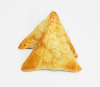 Two traditional South African Samoosa triangles filled with chicken and beef mince isolated on white background 