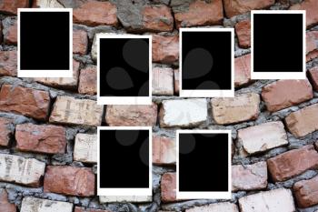 set of six old blank polaroids frames lying on a brick surface 