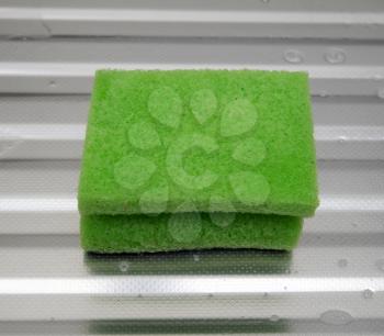 green sponge on a metal surface