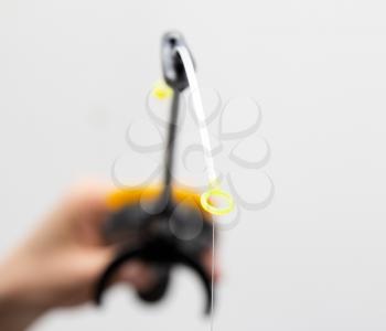 Fishing tackle in a hand on a white background
