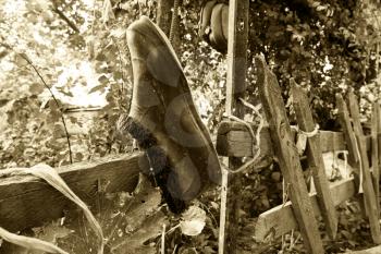 old galoshes hanging on the fence