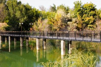 bridge over the lake in the arboretum. Shymkent