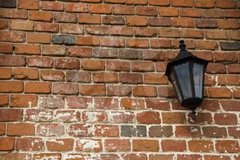 lamp on the old wall with red bricks