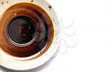 saucer with a dried coffee on a white background