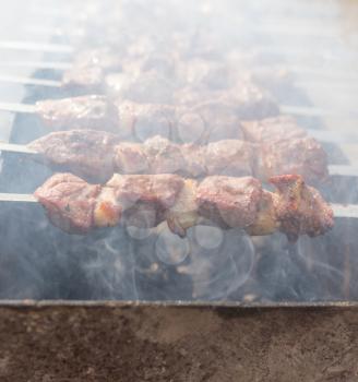 Meat on the grill in the open air .