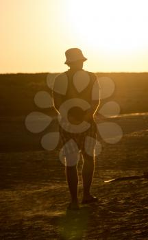 Silhouette of a man in the steppe at sunset