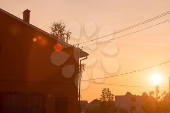 brick house on the golden sunset as a background .