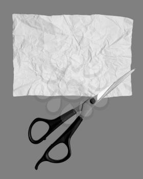Scissors cut paper on a gray background