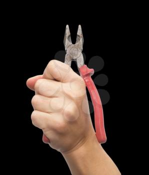 pliers in hand on a black background