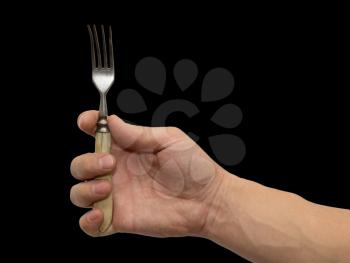 dining fork in hand on a black background