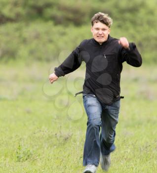 man running in a meadow