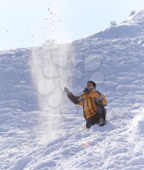 man throws snow in the winter
