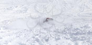 People fell on a snowboard in the snow in the winter
