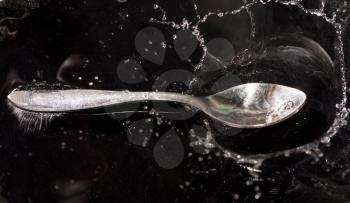 Spoon in a spray of water