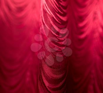 Red fabric curtain as a backdrop.