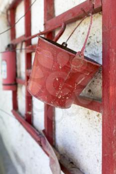 red fire bucket on the wall