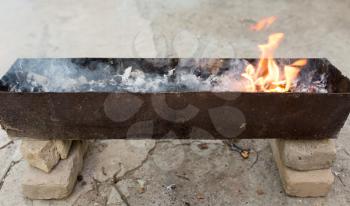 burning wood in a brazier